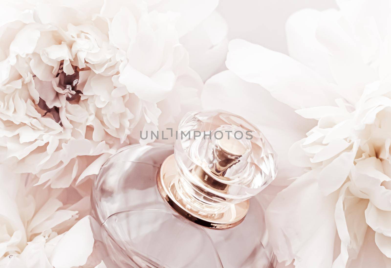 Fragrance bottle as luxury perfume product on background of peony flowers, parfum ad and beauty branding design