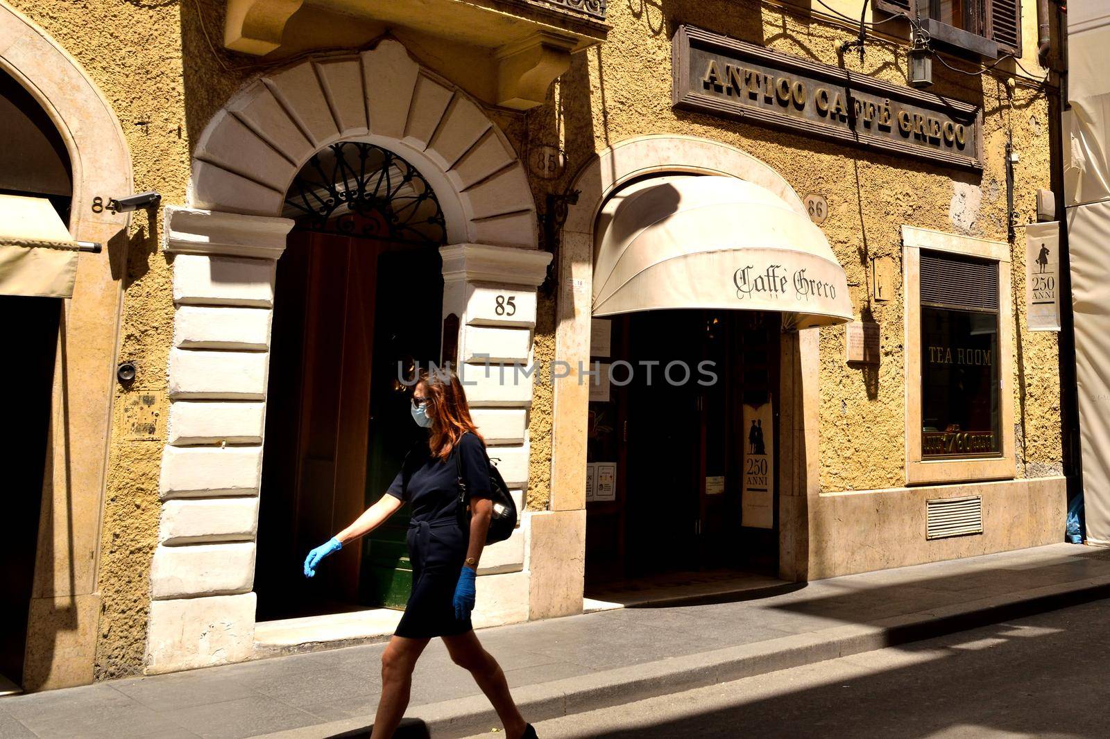 View of the Antico Caffe Greco in Via dei Condotti without tourists due to the phase 2 of lockdown by silentstock639