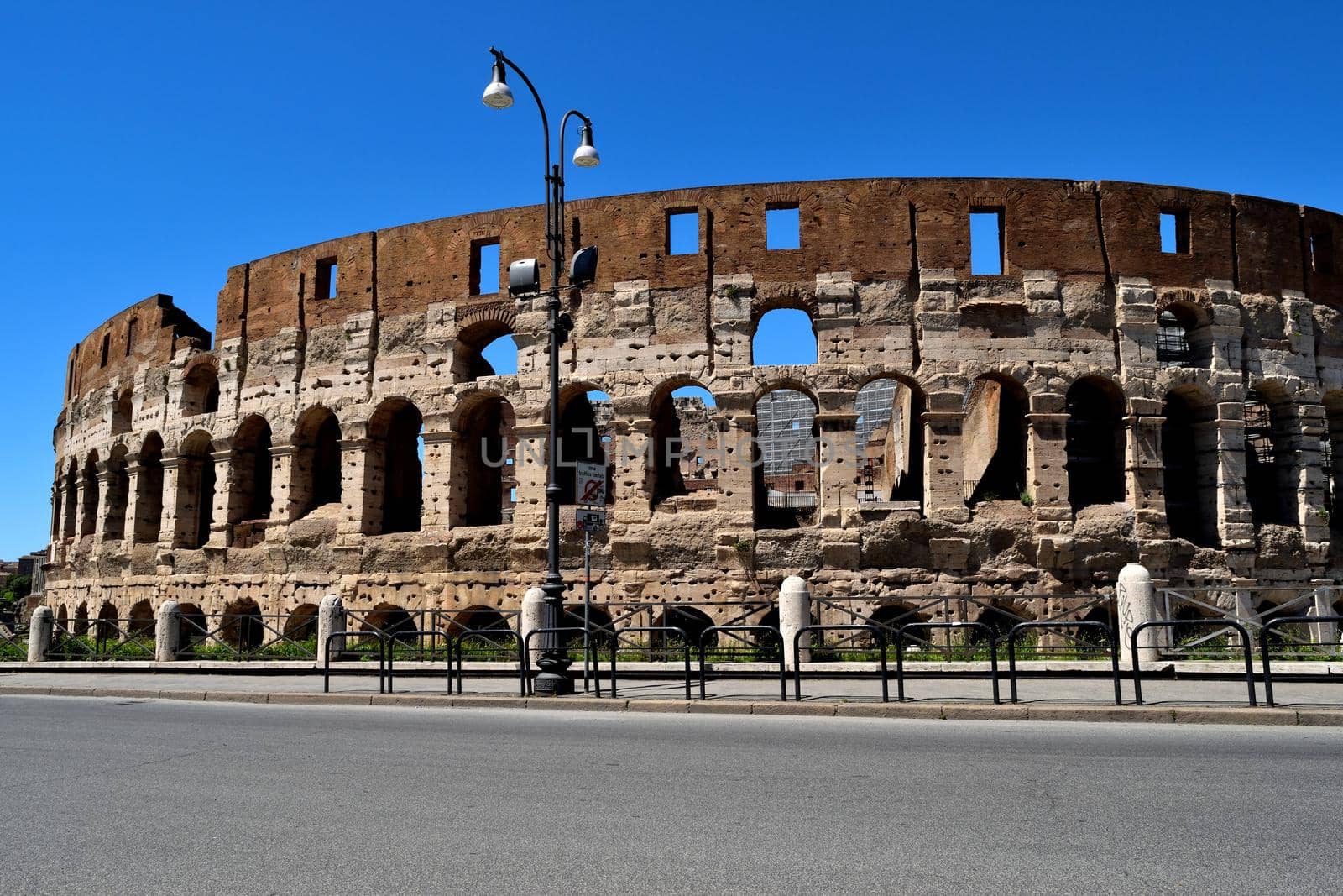 View of the Colosseum without tourists due to the phase 2 of lockdown by silentstock639