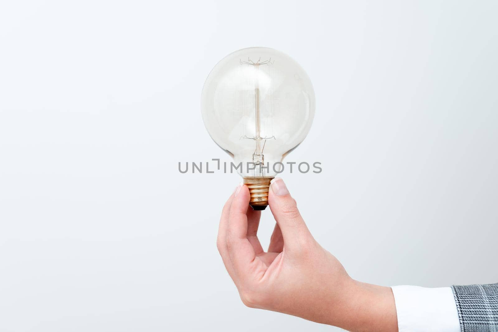 Woman Hand Holding Lamp Presenting Ideas For Project, Man Fists Showing Bulb And New Technologies, Held Lightbulb Exhibiting Another Opinion.