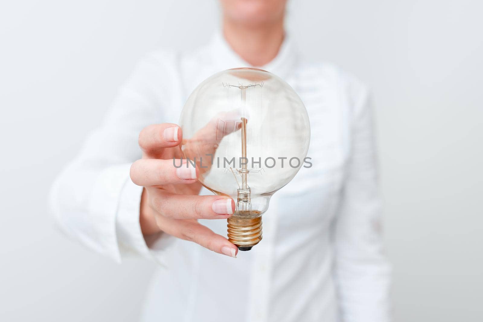 Lady Holding Lamp With Formal Outfit Presenting New Ideas For Project, Business Woman Showing Bulb With One Hand Exhibiting New Technologies, Lightbulb Presenting Another Openion.