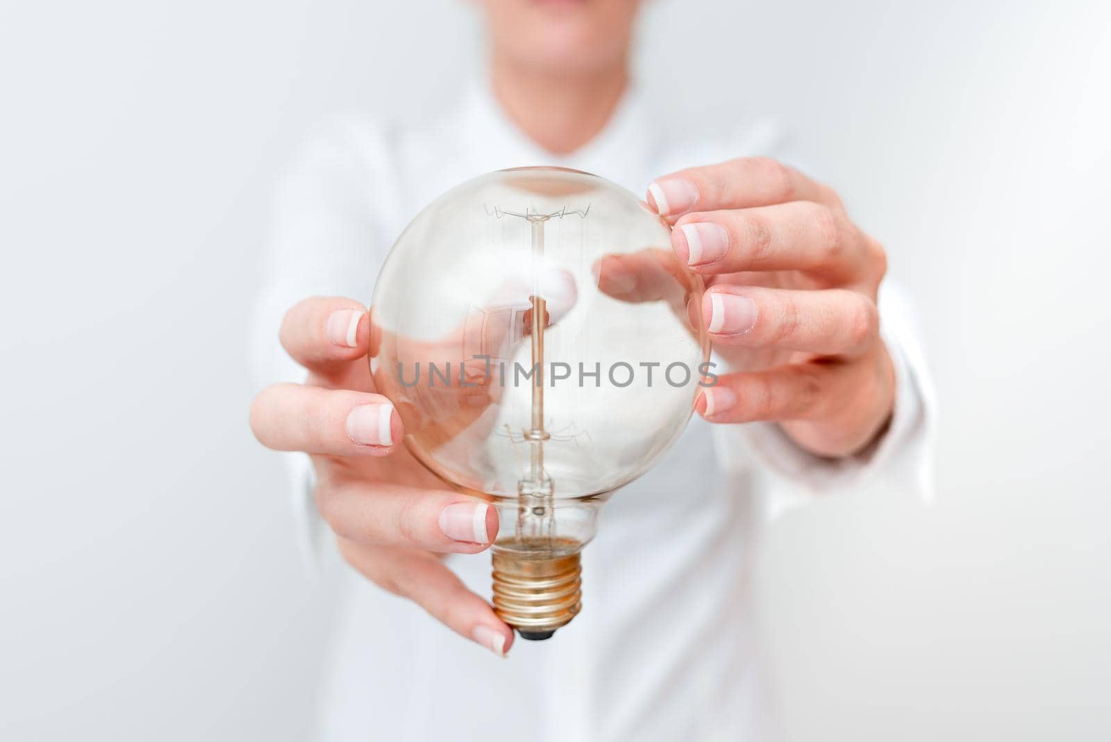 Lady Holding Lamp With Formal Outfit Presenting New Ideas For Project, Business Woman Showing Bulb With Two Hands Exhibiting New Technologies, Lightbulb Presenting Another Openion.