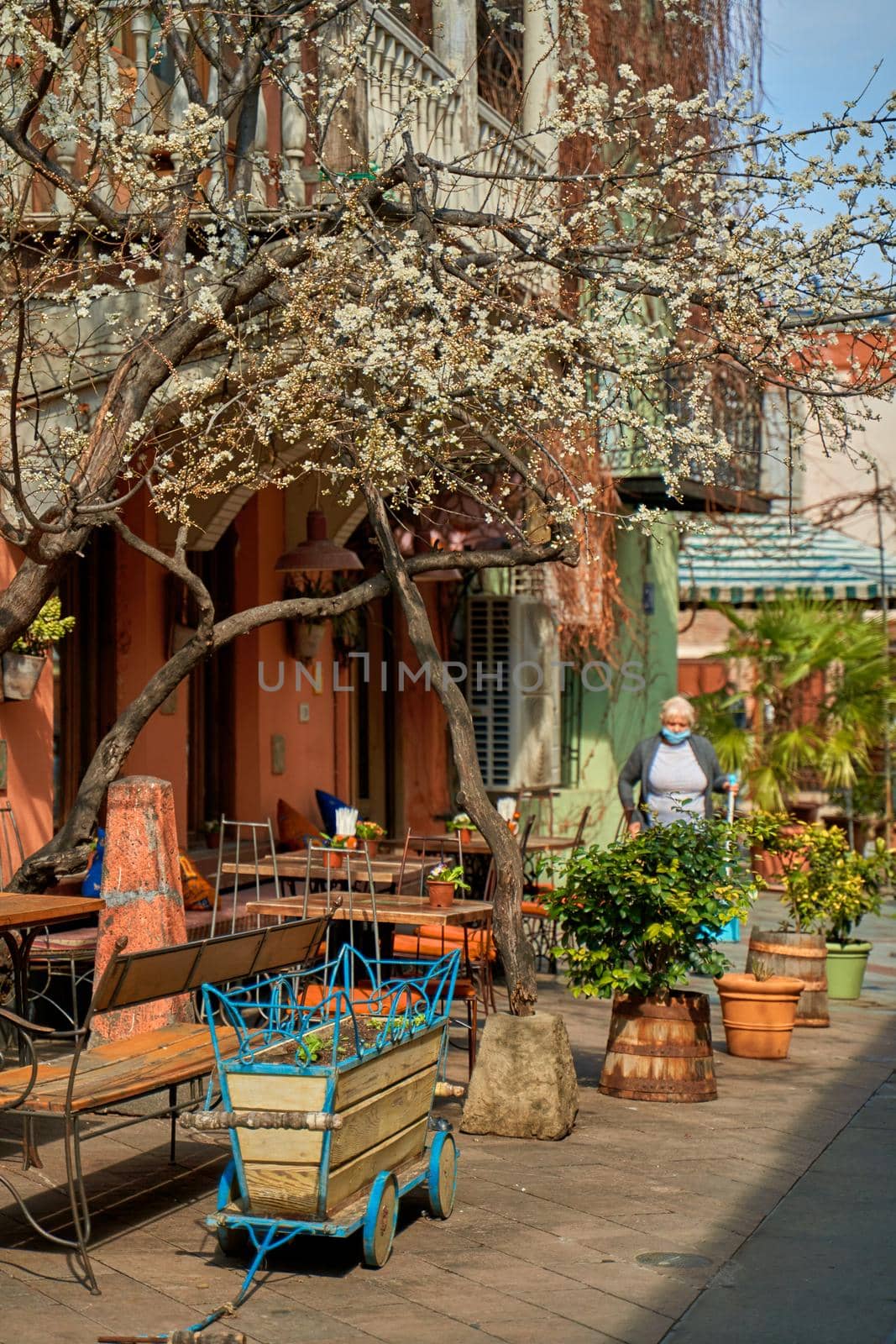 Summer terrace and restaurant table on the street in a cozy old district of Tbilisi. Tbilisi, Georgia - 03.16.2021