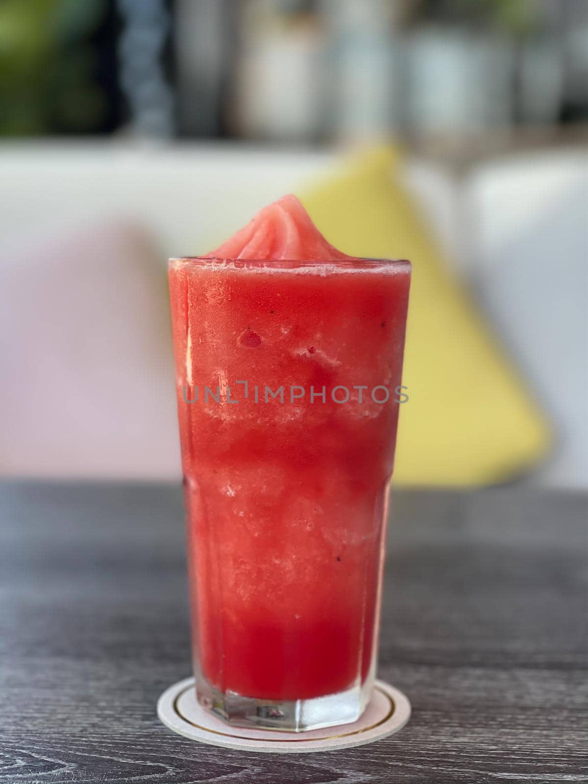 Watermelon smoothie in glass on grey table, stock photo