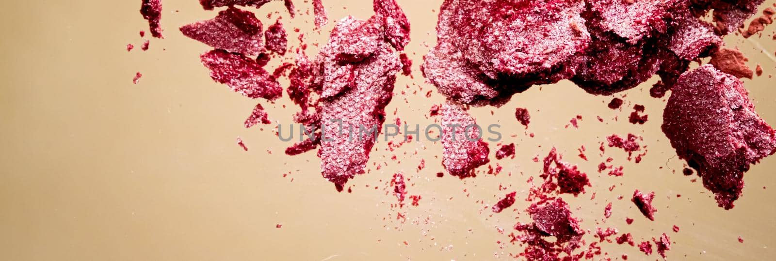 Crushed cosmetics, mineral organic eyeshadow, blush and cosmetic powder isolated on golden background, makeup and beauty banner, flatlay design.