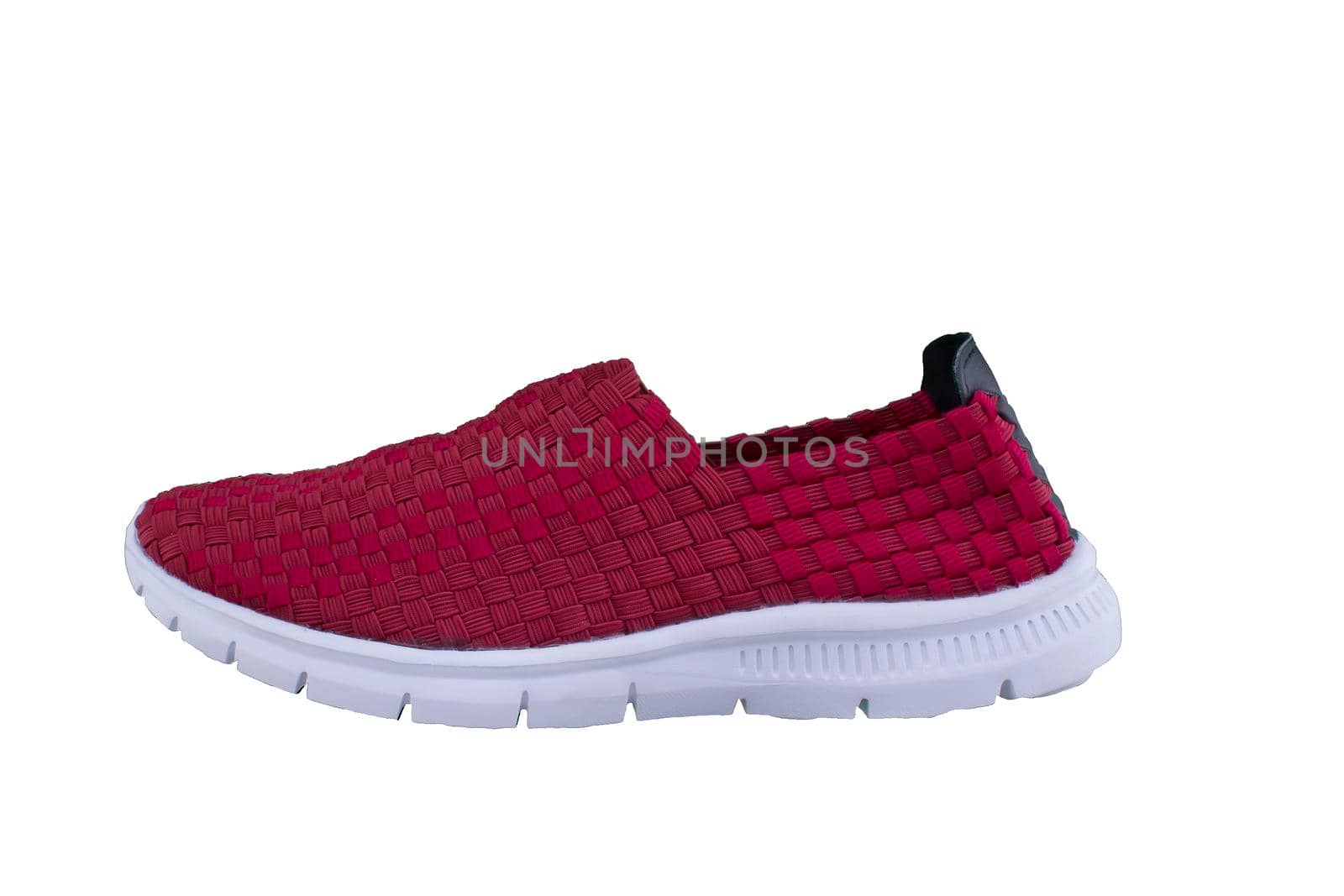 Red sneaker on a white sole. Sport shoes on a white background.