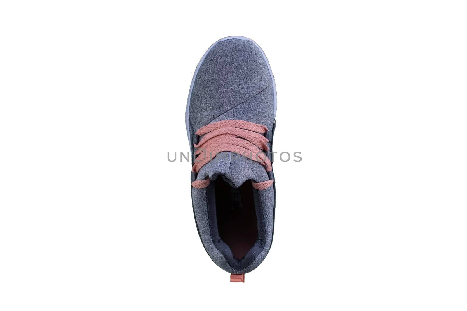 Gray sneaker with orange laces. Sport shoes on a white background top view