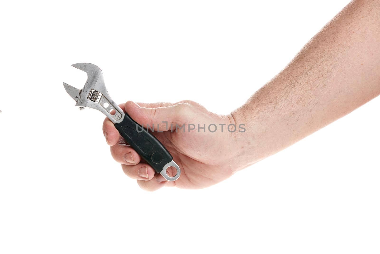 Hand holds an adjustable wrench on a white background, template for designers.