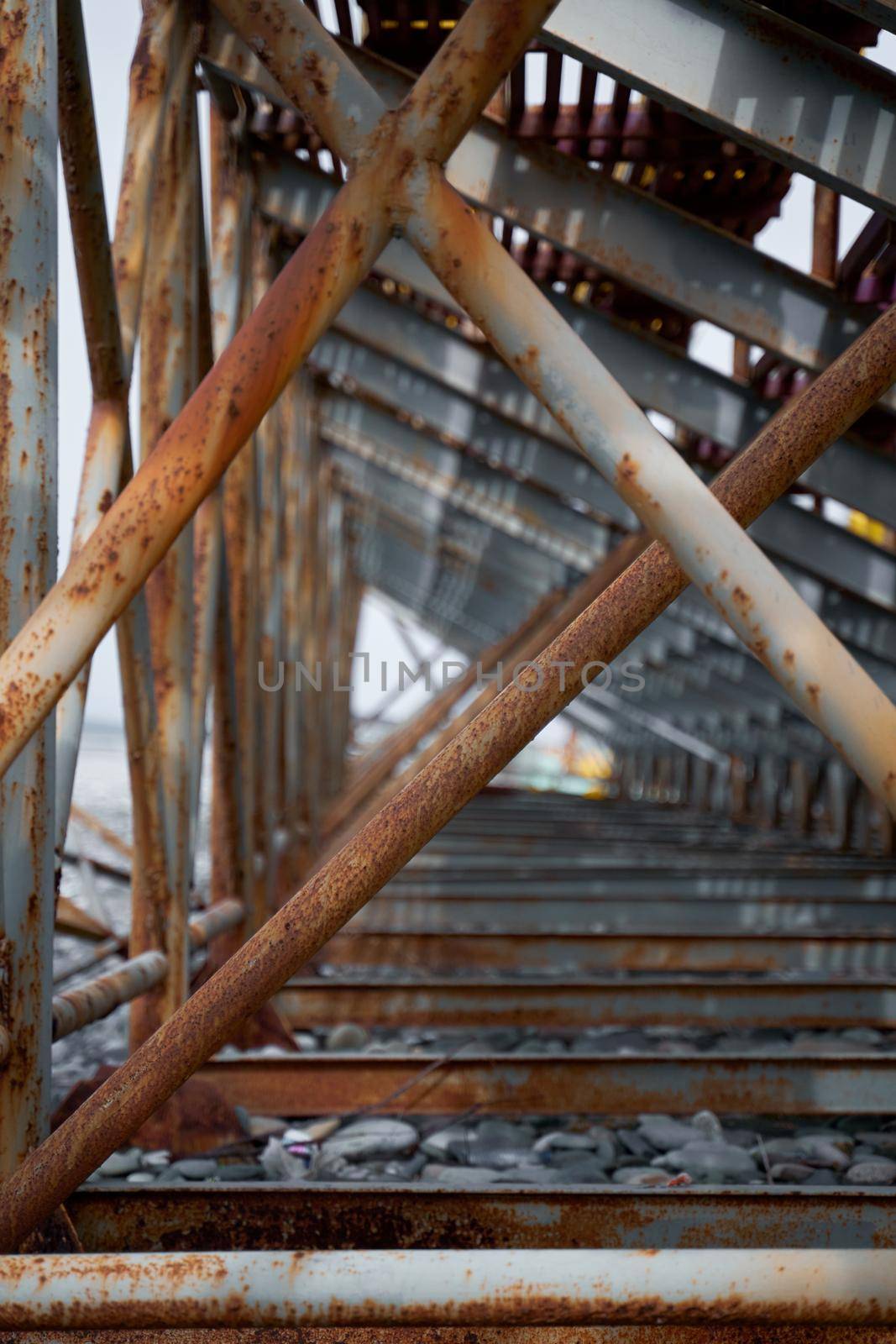 Rusty support pipes of the sports field stands. Construction fittings.