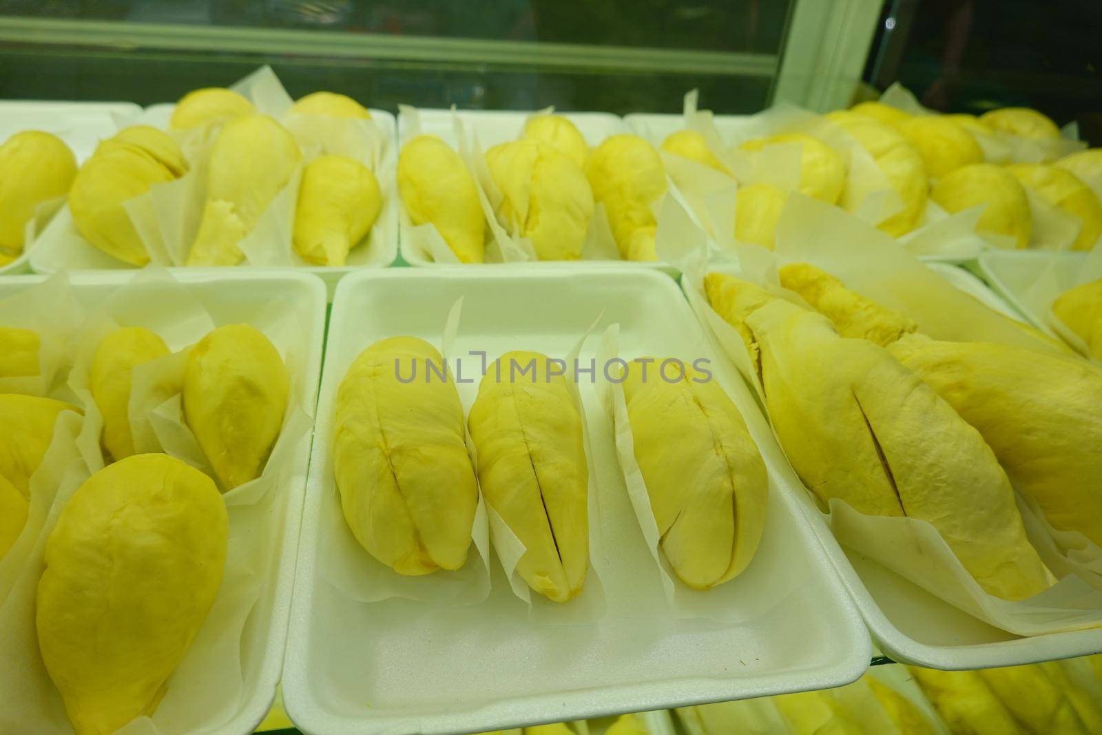 durian fruit in packages on sale in market, yellow durian in packaging as seasonal fruit of Thailand. 