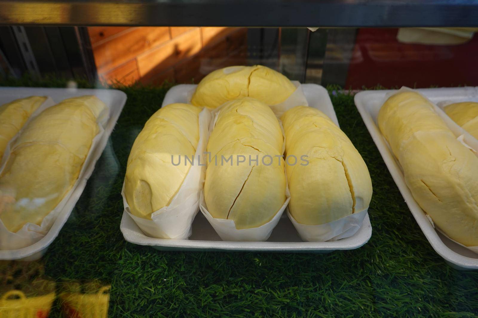 durian fruit in packages on sale in market, yellow durian in packaging as seasonal fruit of Thailand. 