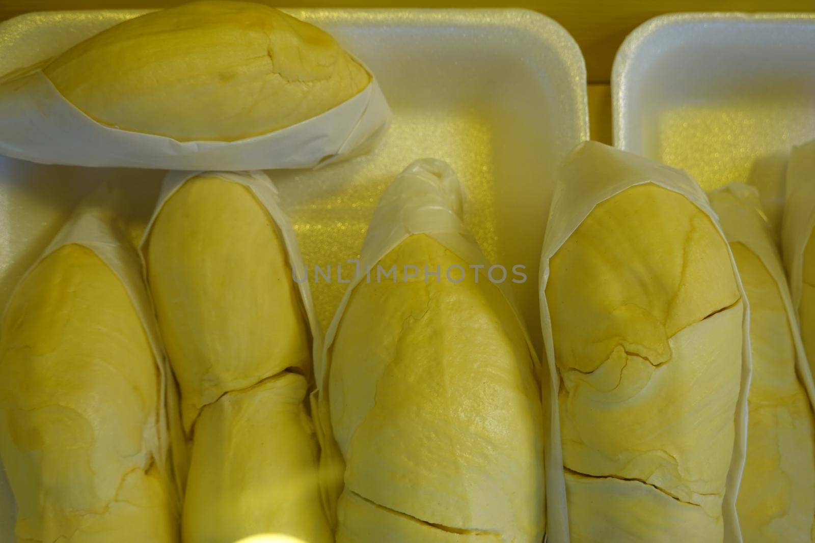 durian fruit in packages on sale in market, yellow durian in packaging as seasonal fruit of Thailand. 