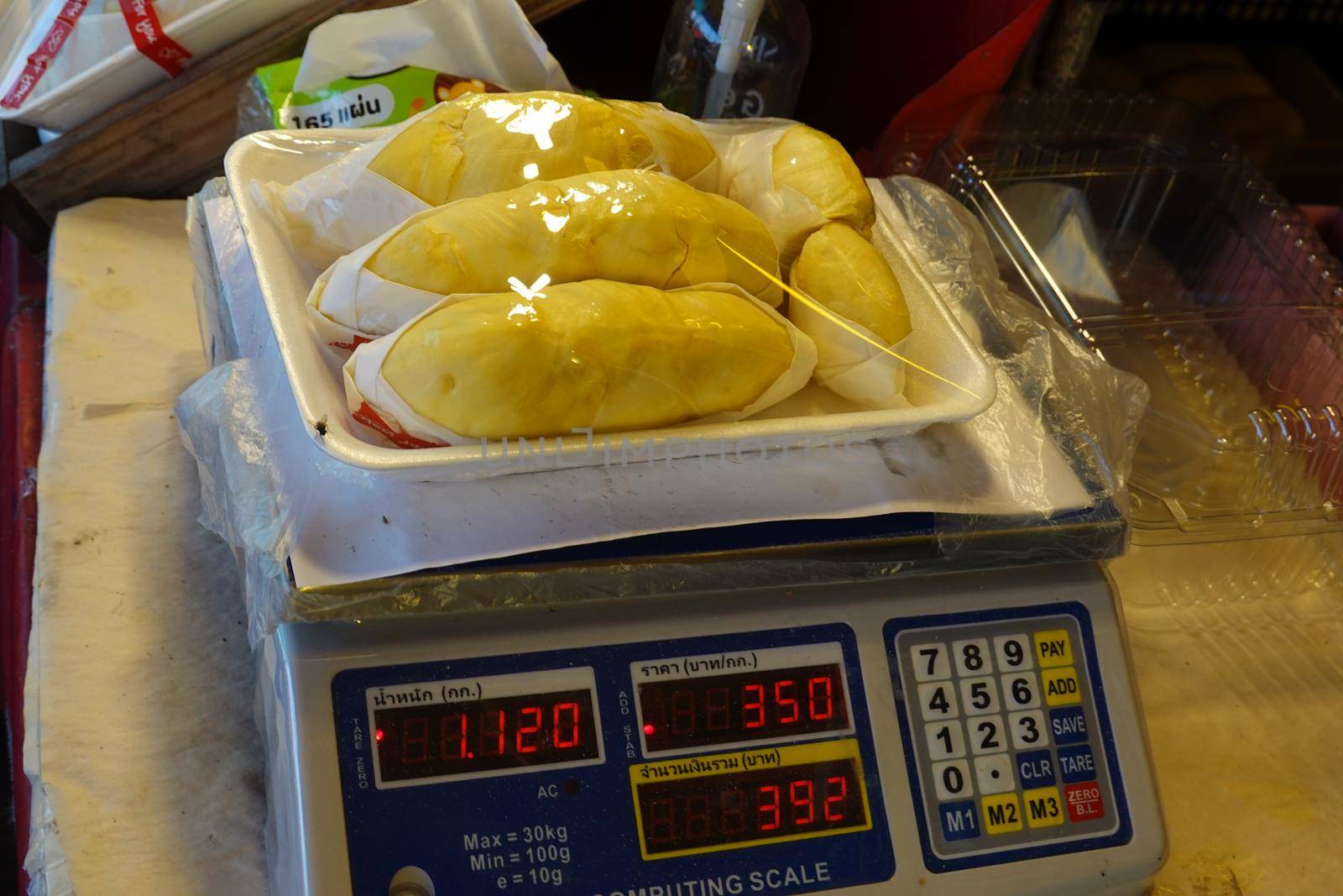 durian fruit in packages on sale in market, yellow durian in packaging as seasonal fruit of Thailand. 