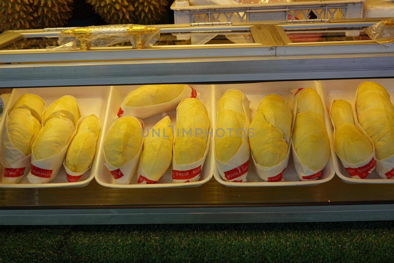 durian fruit in packages on sale in market, yellow durian in packaging as seasonal fruit of Thailand. 