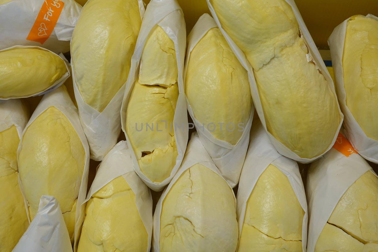 durian fruit in packages on sale in market, yellow durian in packaging as seasonal fruit of Thailand. 