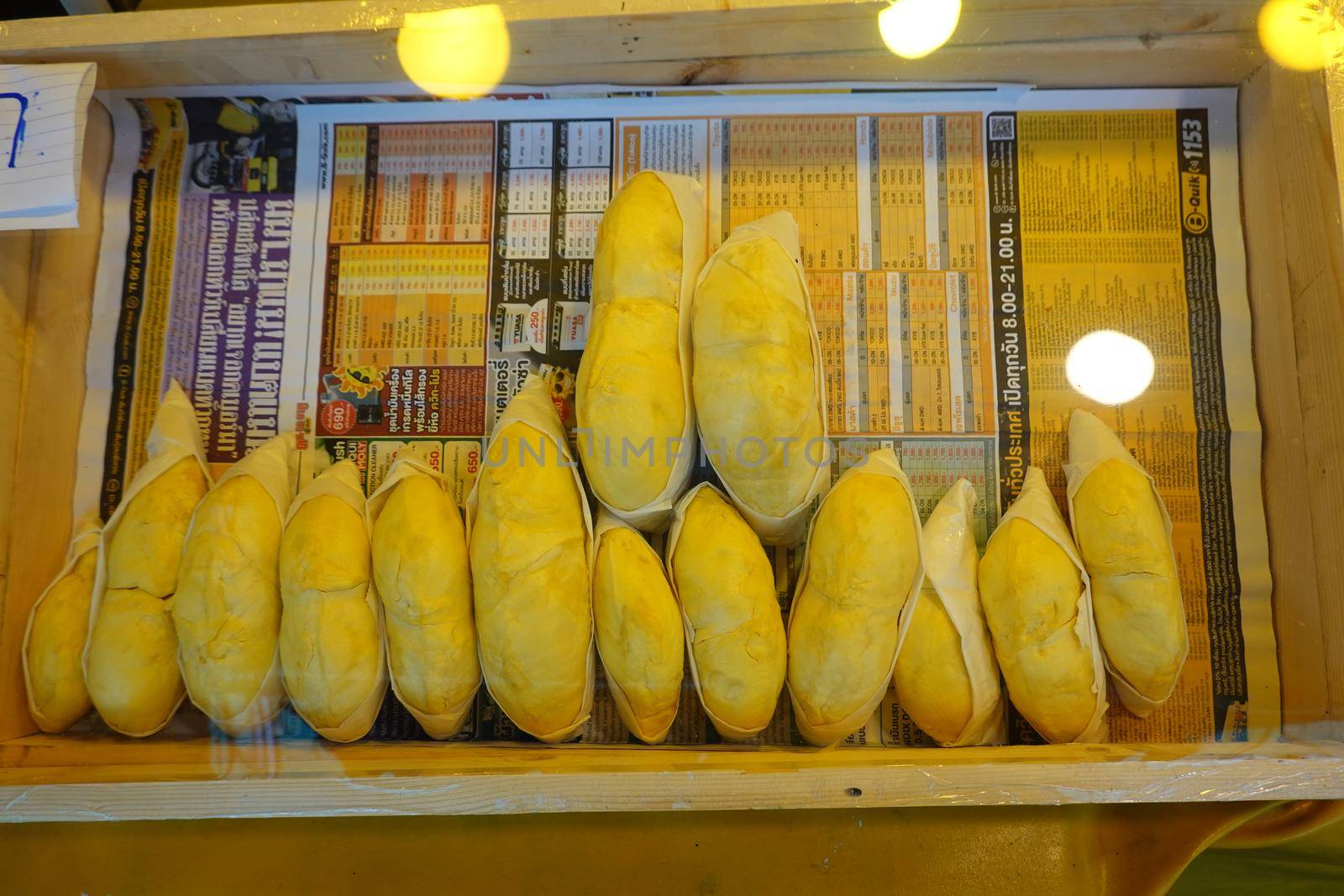 durian fruit in packages on sale in market, yellow durian in packaging as seasonal fruit of Thailand. 