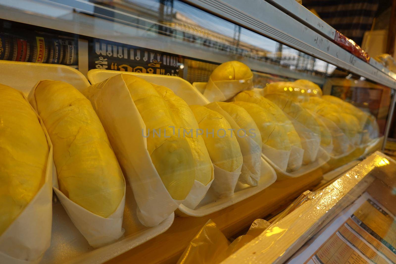 durian fruit in packages on sale in market, yellow durian in packaging as seasonal fruit of Thailand. 