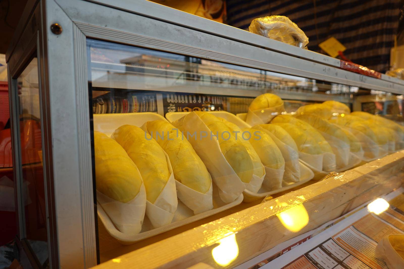 durian fruit in packages on sale in market, yellow durian in packaging as seasonal fruit of Thailand. 