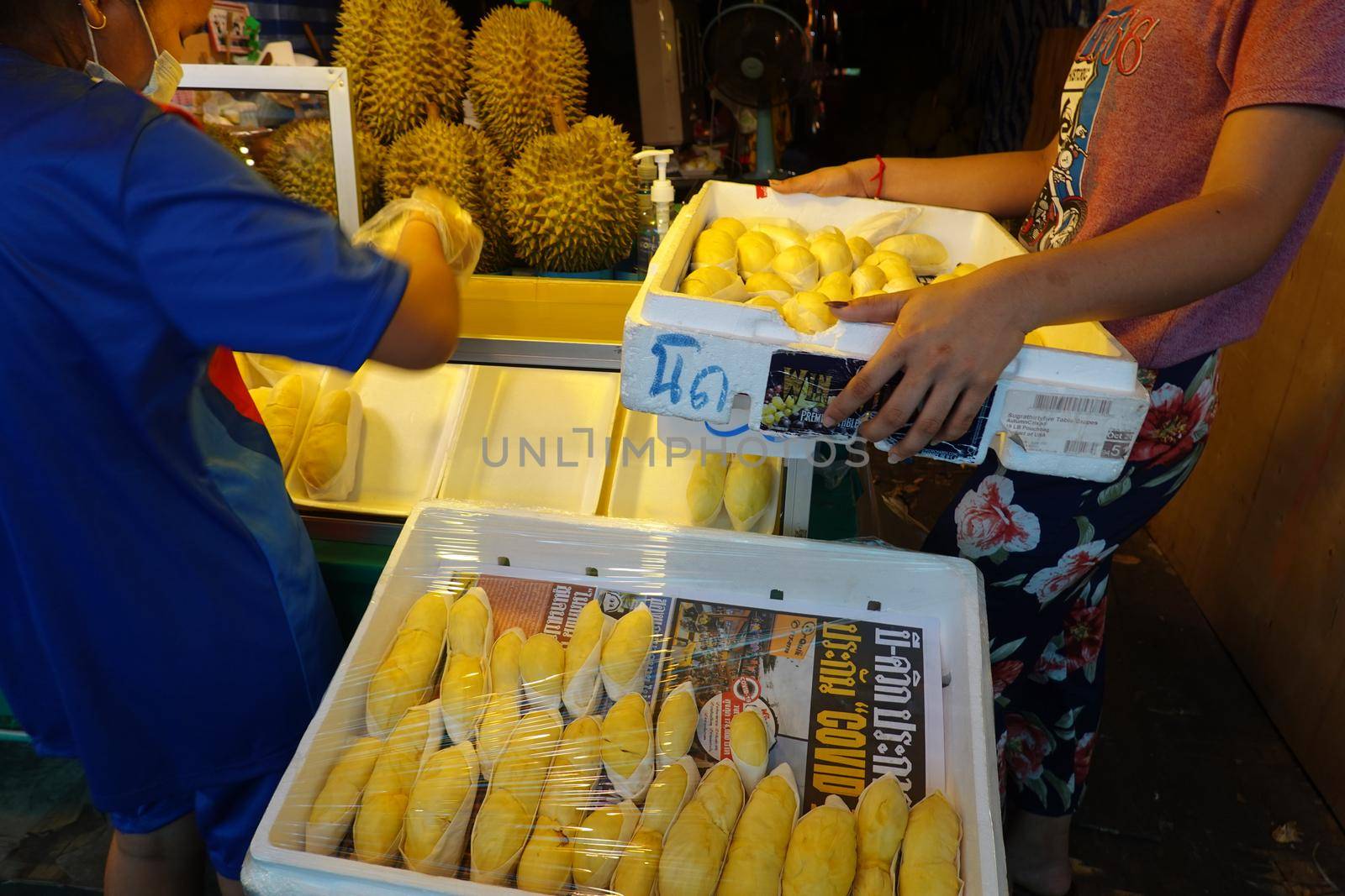 durian fruit in packages on sale in market, yellow durian in packaging as seasonal fruit of Thailand.  by chuanchai