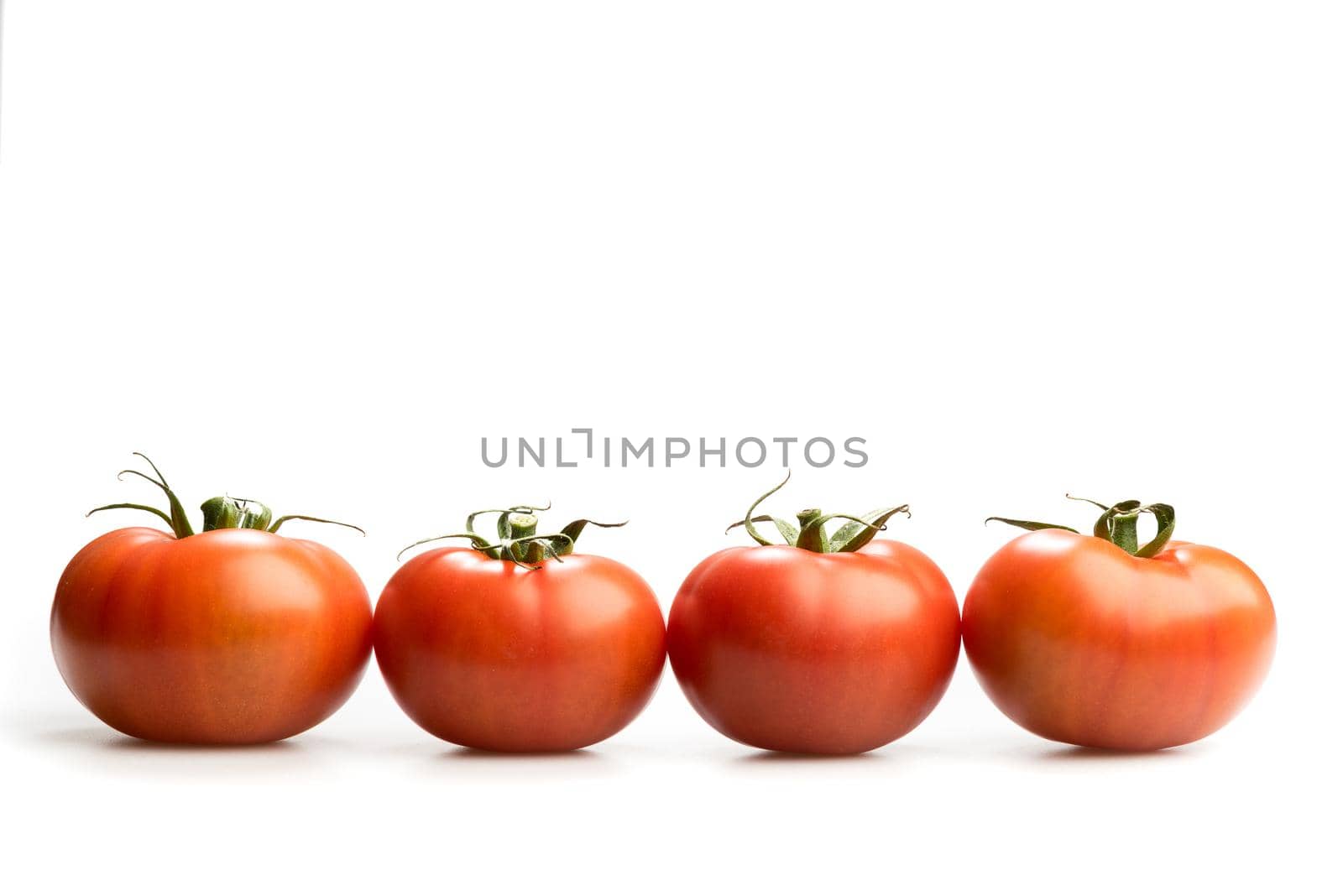 Four realistic red tomatoes in a line isolated in white background  by LeoniekvanderVliet