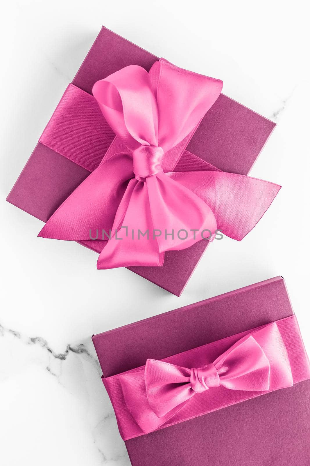 Birthday, wedding and girly branding concept - Pink gift box with silk bow on marble background, girl baby shower present and glamour fashion gift for luxury beauty brand, holiday flatlay art design