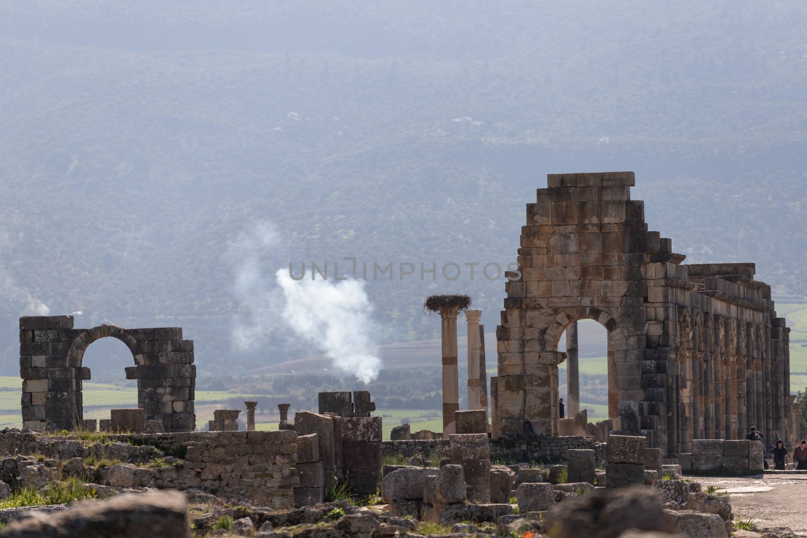 Volubilis is a site of Roman ruins and formerly a partly excavated Berber city in Morocco near the city of Meknes.The images show the ruined buildings and columns that are part of the large site High quality photo