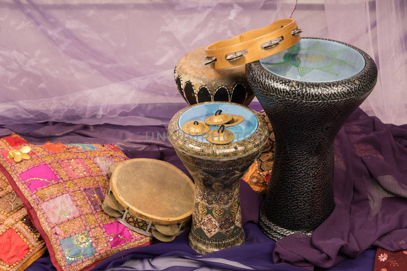 Side view of musical instruments of a bellydance percussiongroup with darbuka's, tambourines and zills by LeoniekvanderVliet