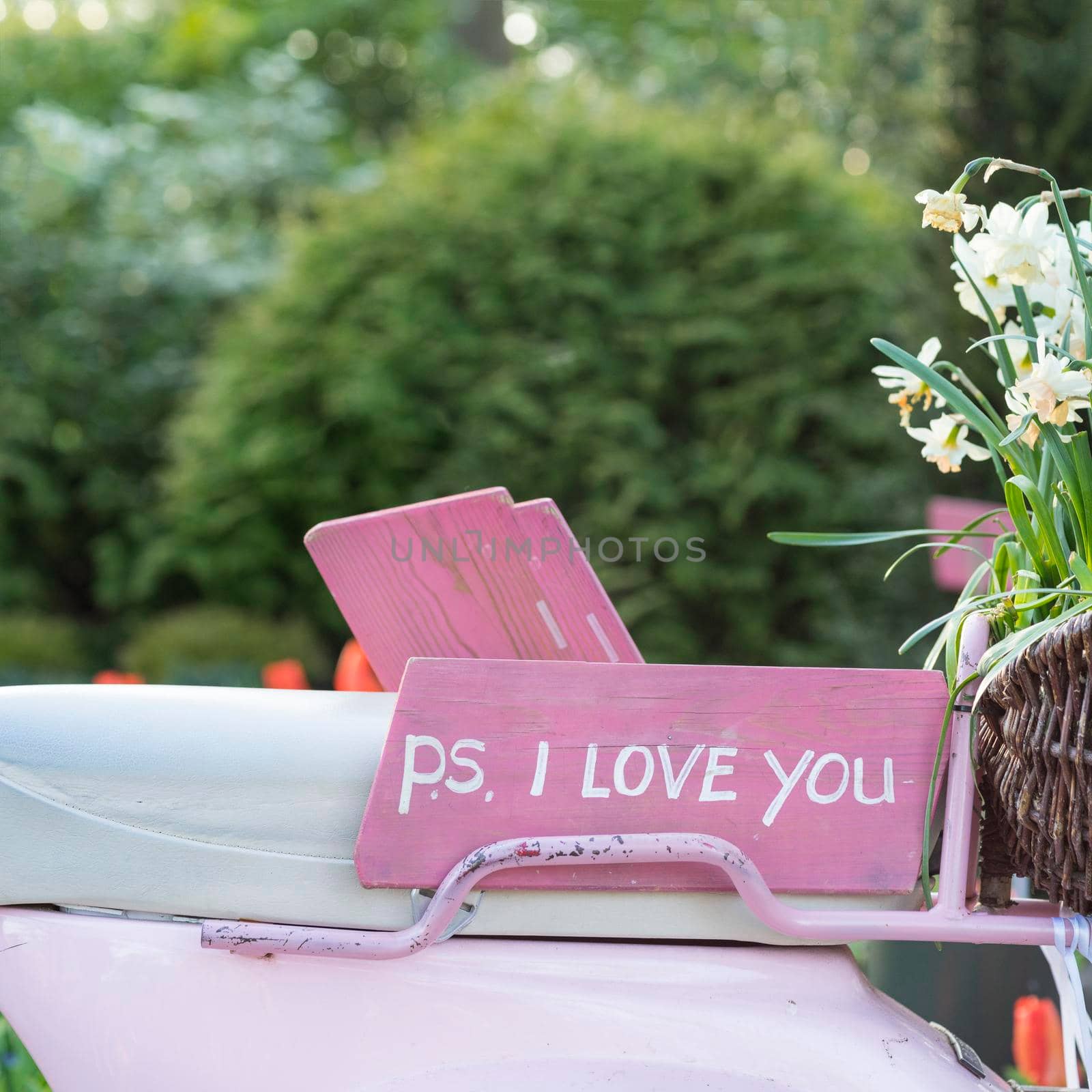 Pink sign on the seat of a scooter saying 'P.S. I love you'