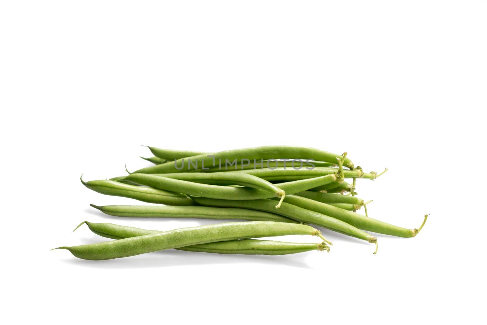 A handful of green beans isolated on a white background by LeoniekvanderVliet