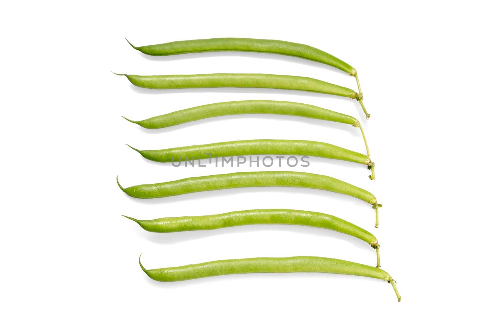 A handful of green beans isolated on a white background