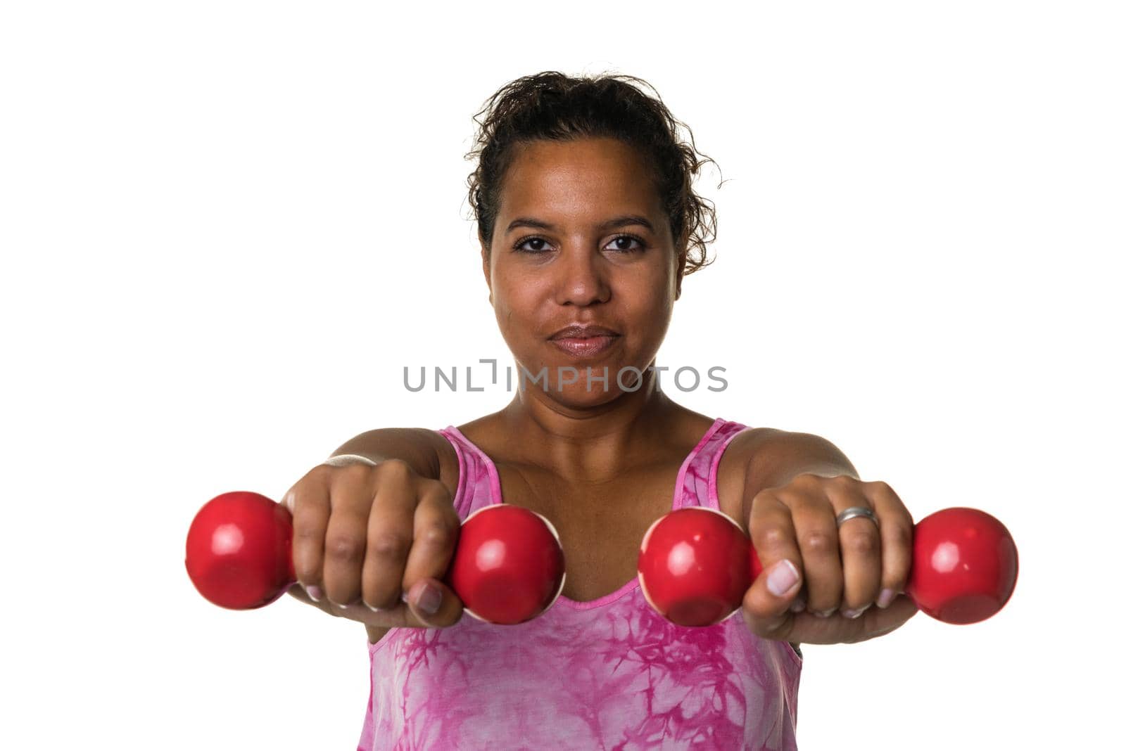 Mixed raced young woman  in pink shirt exercising with red 2 kg weights dumbbells isolated in white