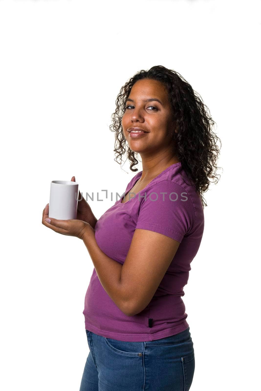 Young mixed race woman in purple shirt drinking a hot liquid from a black and white cup isolated with a white background by LeoniekvanderVliet