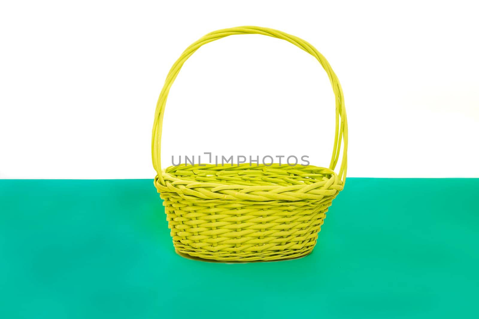 Empty green yellow basket isolated on a white and green background