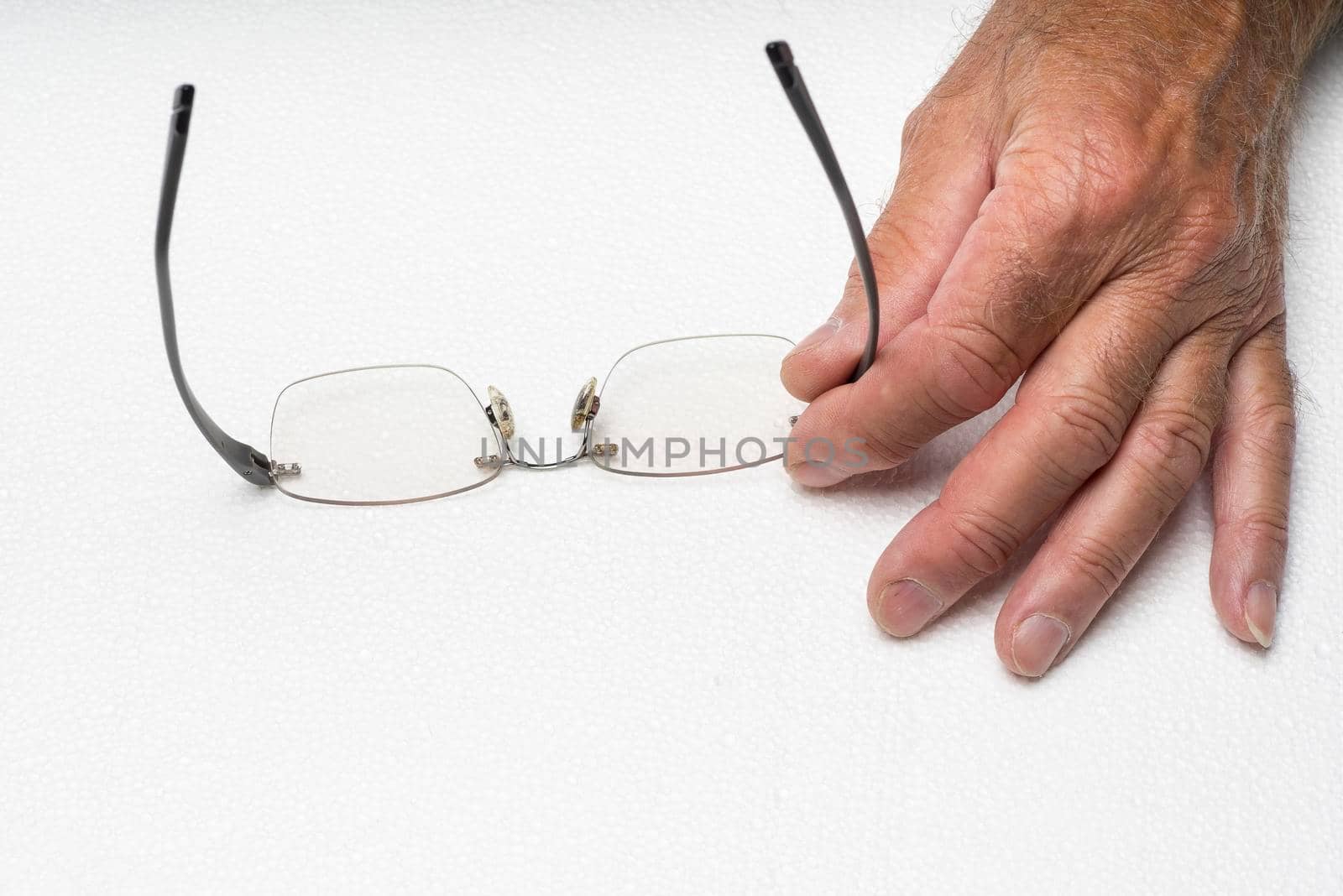 Eye glasses frameless in the hand on white background. Eye glasses no frame held in the hand on white background