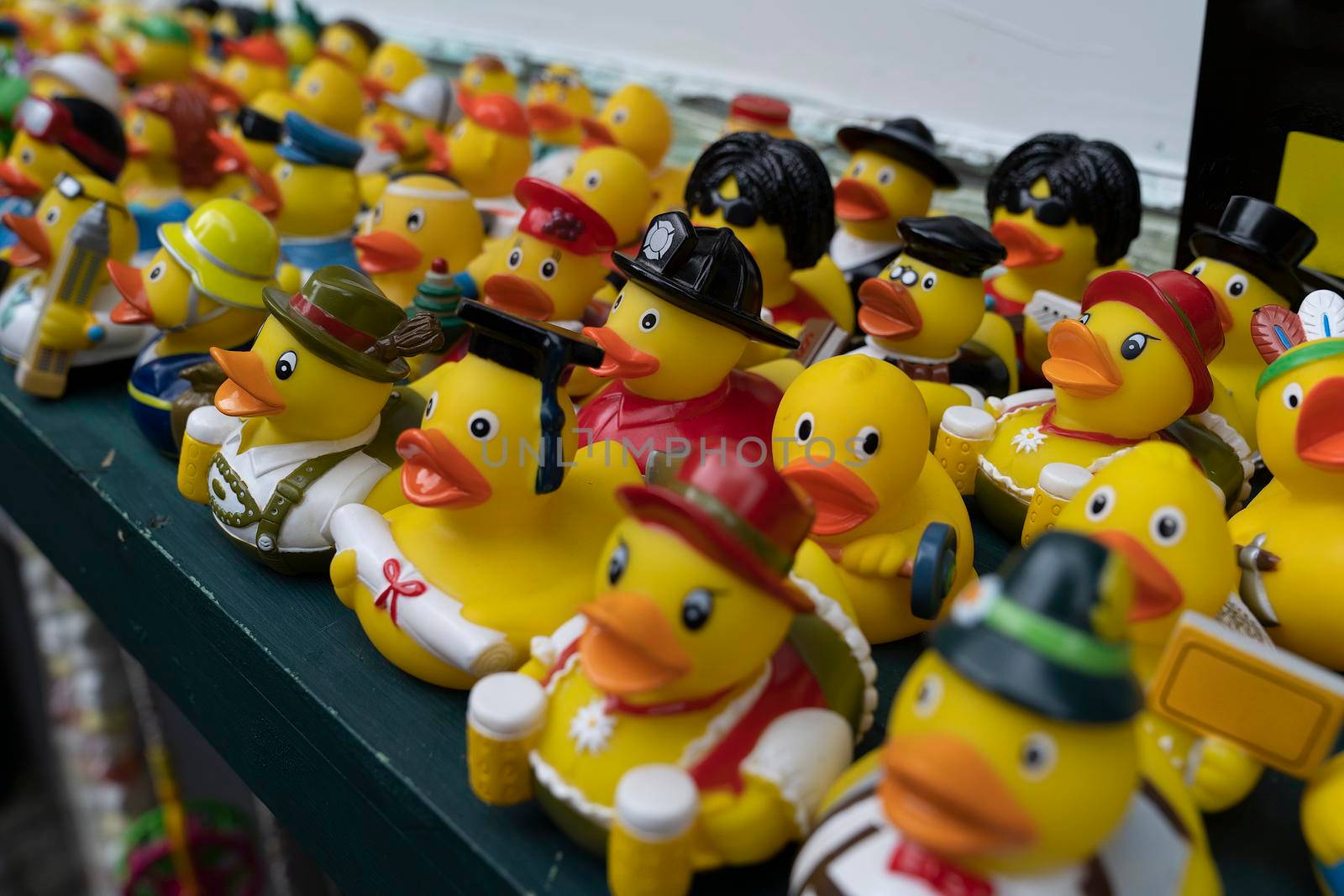 A group with many figurines rubber ducks bathing toys on a shelf with selective focus on the middle by LeoniekvanderVliet