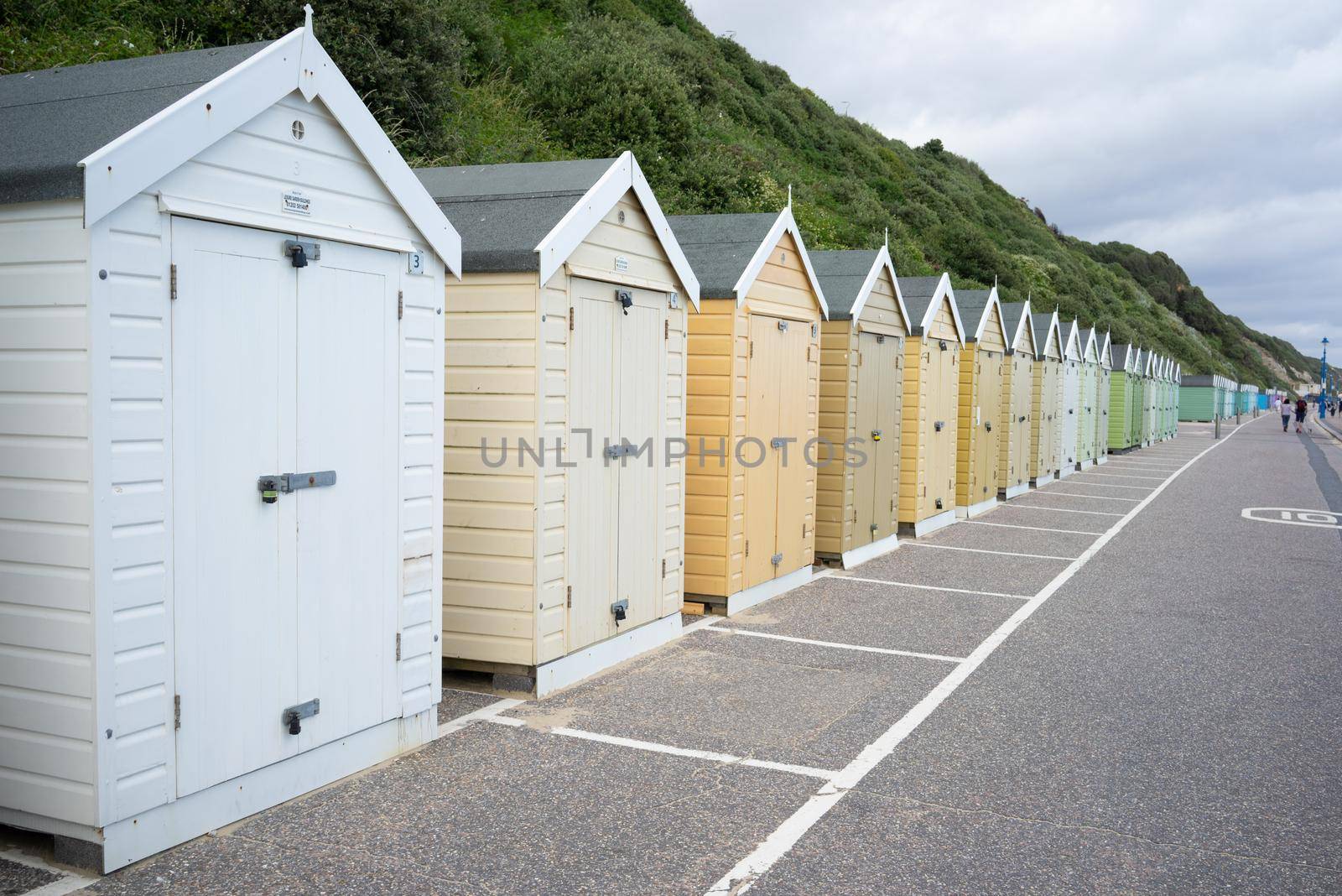 Colorful Beach huts, in beige and white colors, at the  boulevard in Bournemouth, Dorset, UK, England on cloudy day in summer