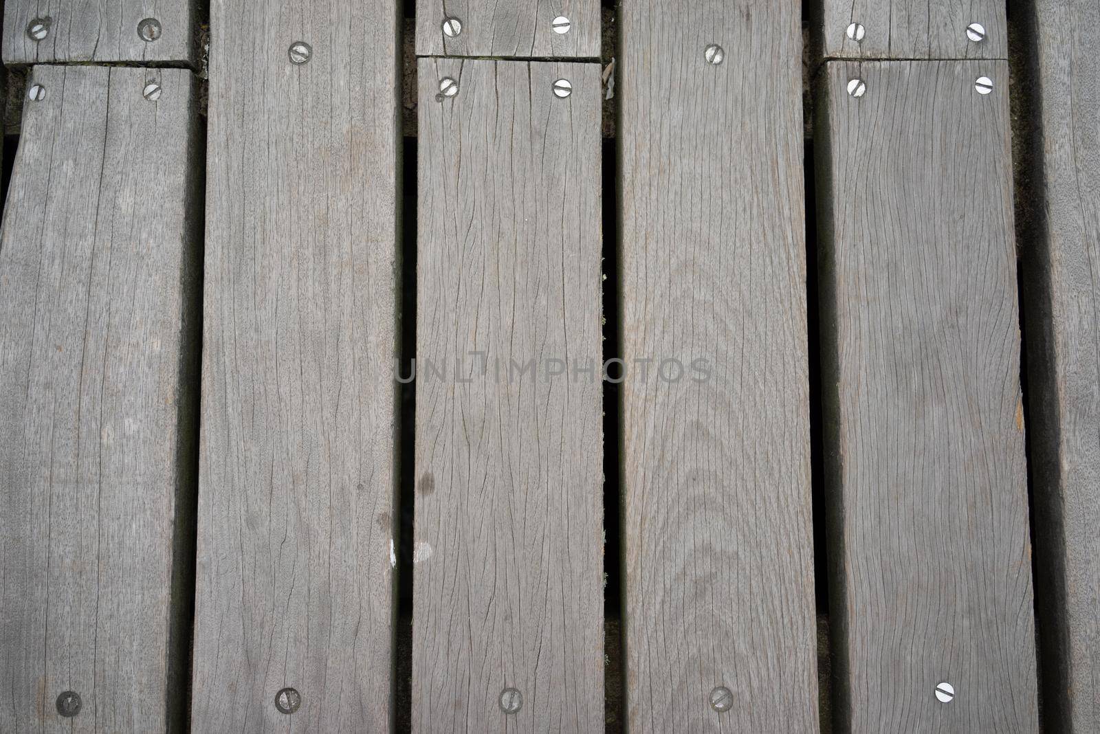 Wooden planking or landing on a pier, background with structure and pattern use for copy space by LeoniekvanderVliet