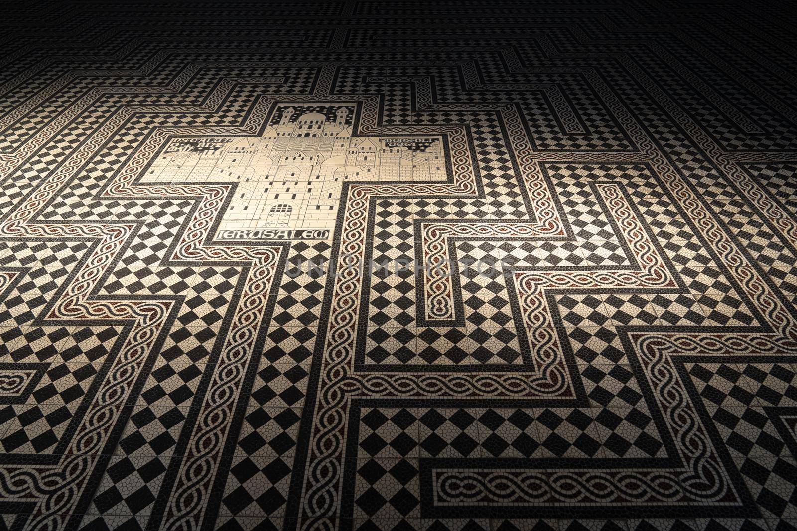 A background or floor with mosaic tiles showing a cross and the city of Jerusalem at the floor of a church with copy space by LeoniekvanderVliet