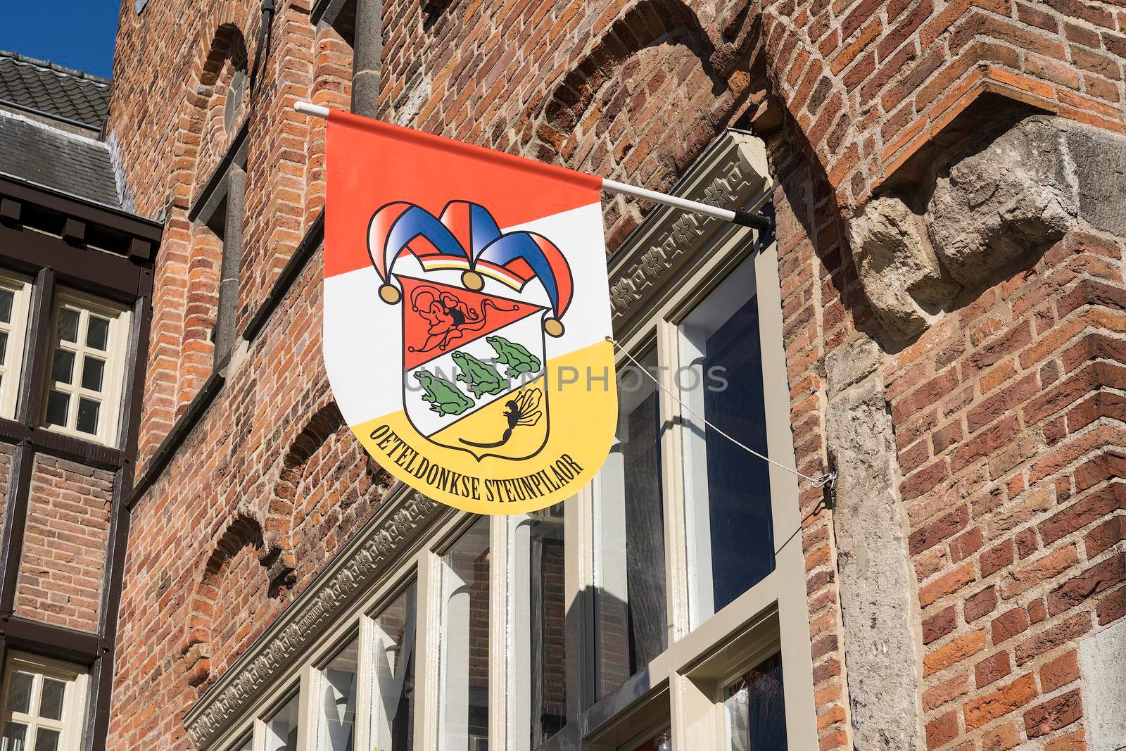 Dutch flag, in red, white and yellow, of traditional festival named Carnaval, like Mardi Gras, in 's-Hertogenbosch, Oeteldonk hanging on a building by LeoniekvanderVliet