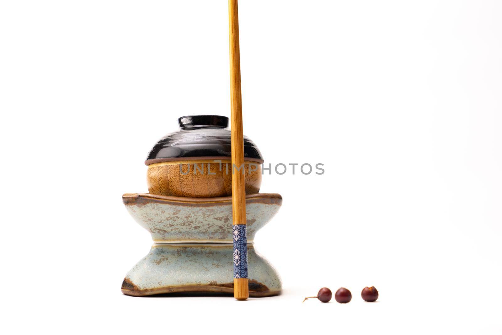 Still life of a japanese figure built from cups and a chopstick isolated on a white background by LeoniekvanderVliet