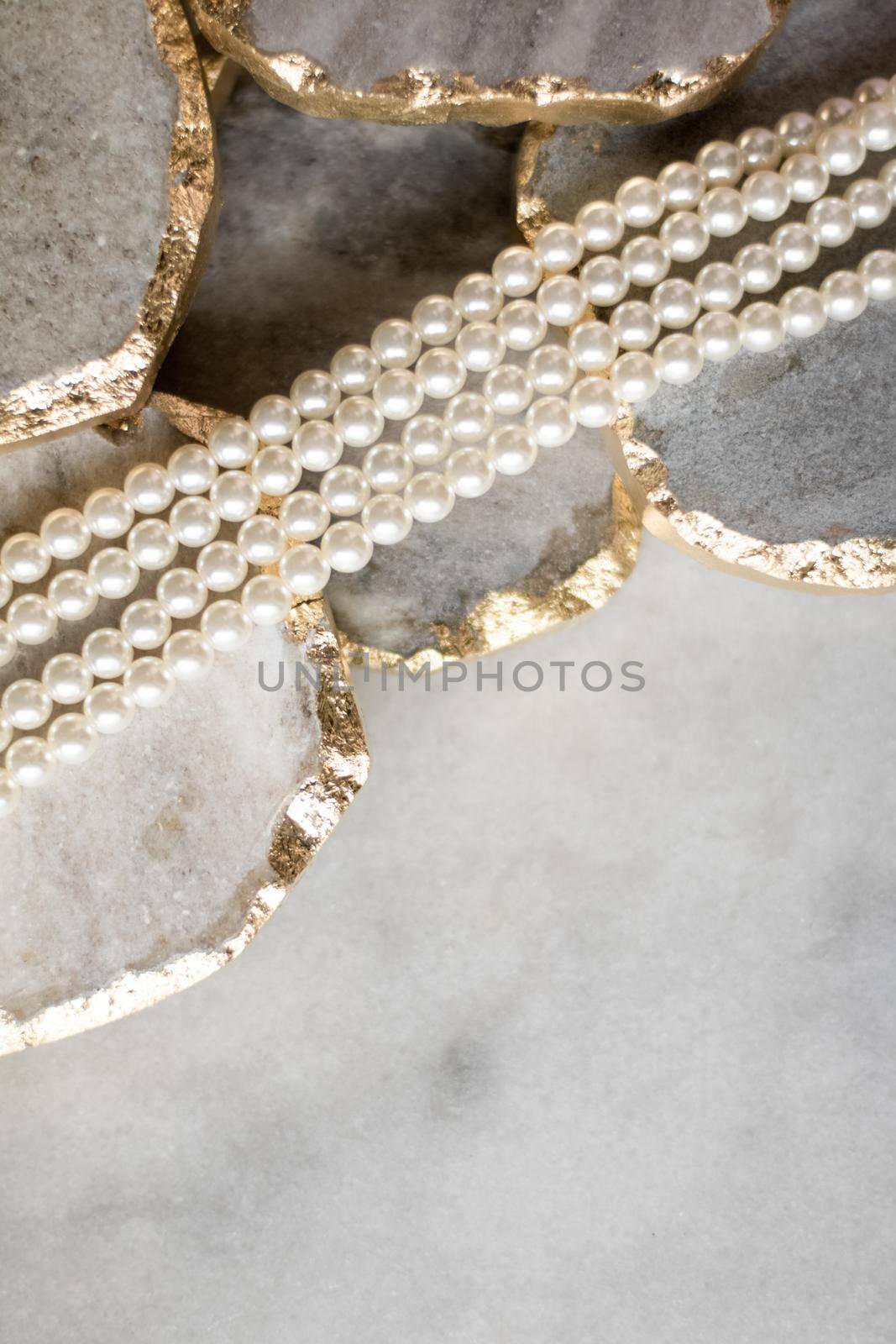 Pearl necklace on golden marble, ethical jewellery - luxury background, jewelry as a gift concept. Pearls are girl's best friends