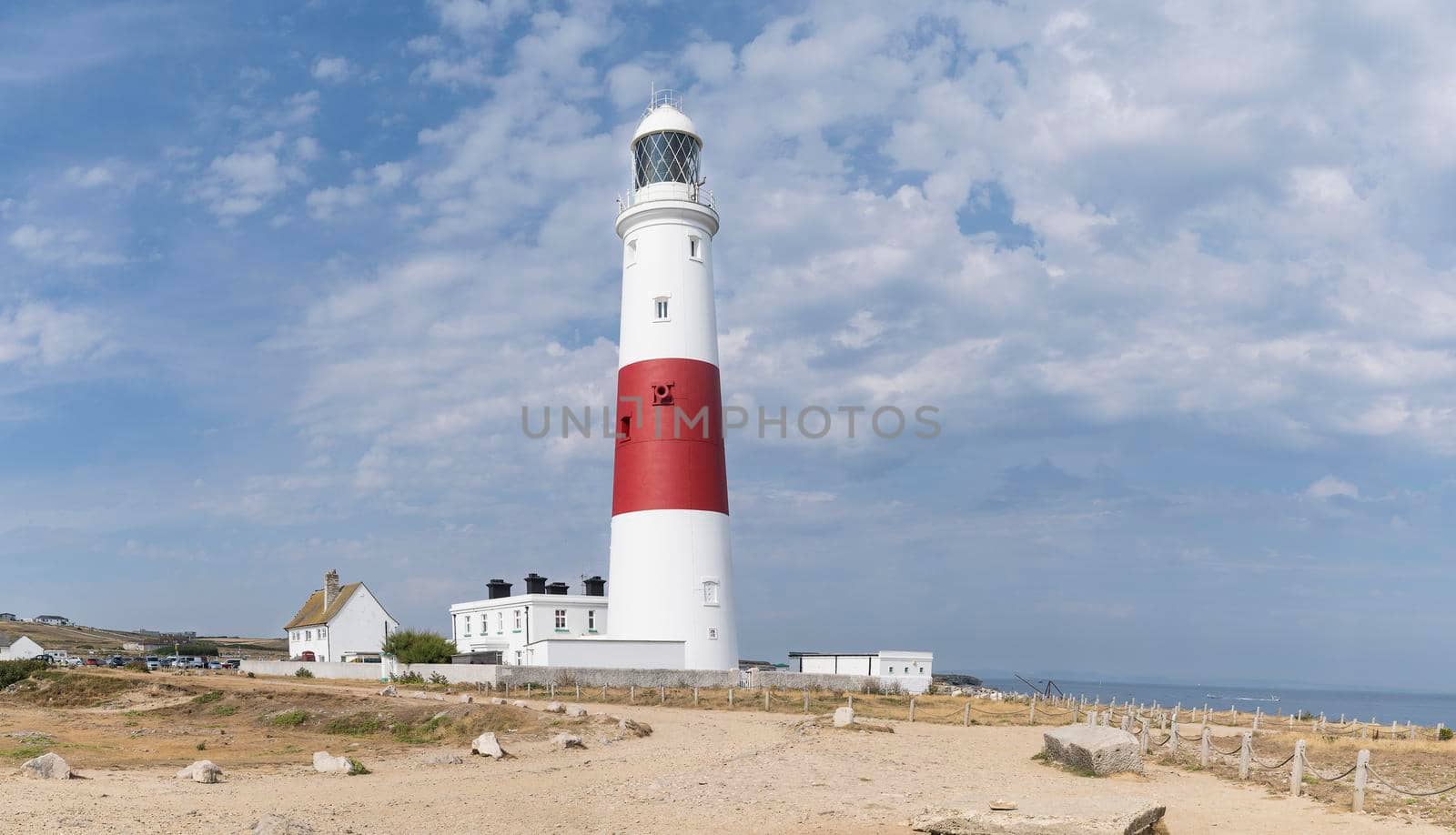 a Panoramic view of the Isle of Portland bill lighthouse near Weymouth Dorset coast England UK with a cloudy sky and the ocean in the summer