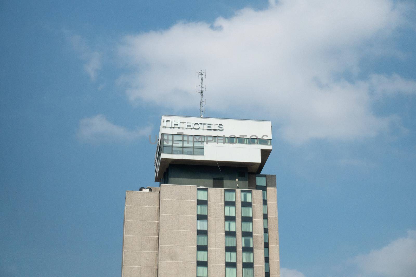 UTRECHT, NETHERLANDS - april 15 2019: NH Hotels building with logo at Jaarbeursplein against blue sky by LeoniekvanderVliet