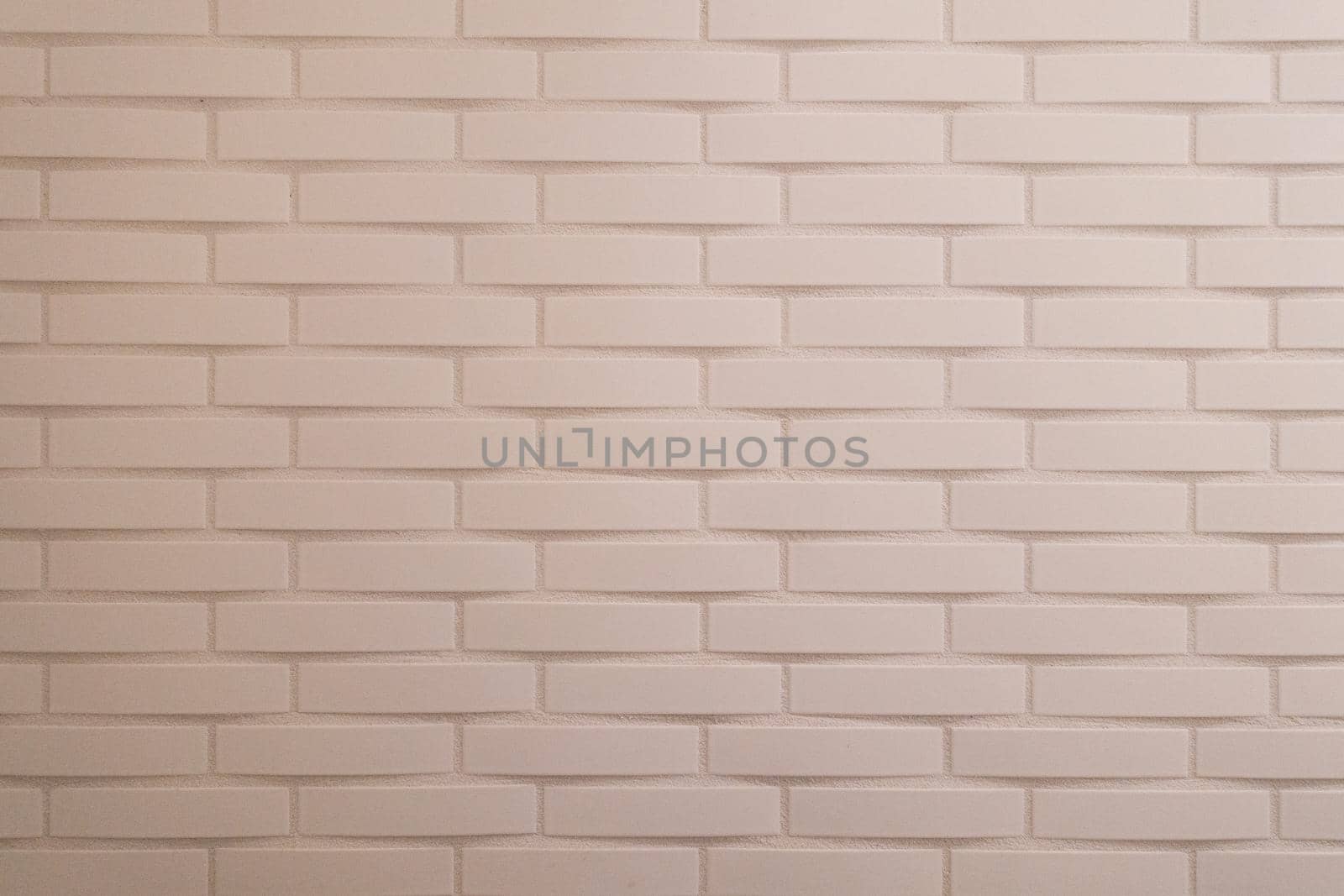 Soft pink painted brick wall with horizontal lines by LeoniekvanderVliet