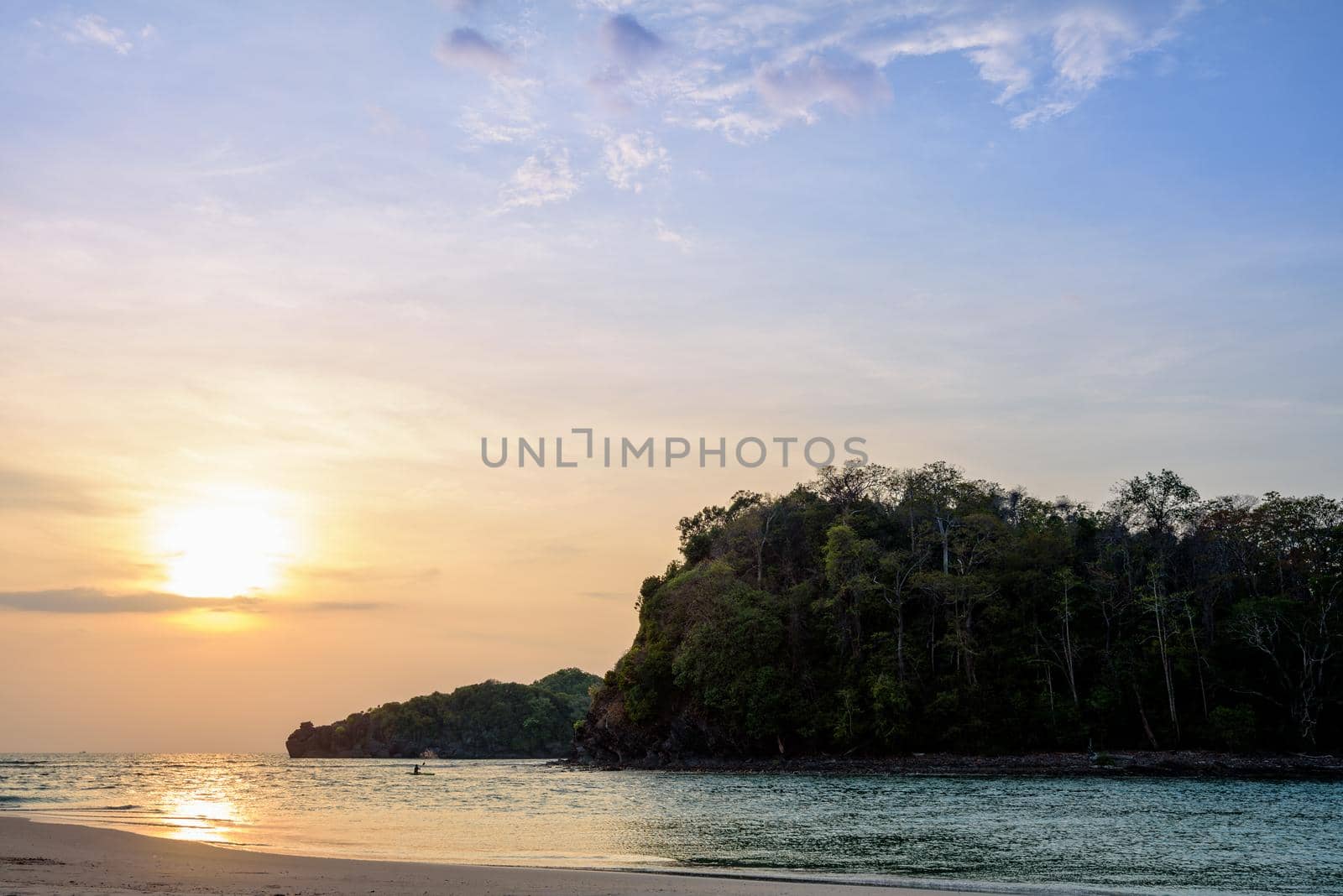 Beautiful nature landscape of colorful the sun on the sky at Tarutao island beach during the sunset over the Andaman Sea, Tarutao National Park, Satun, Thailand