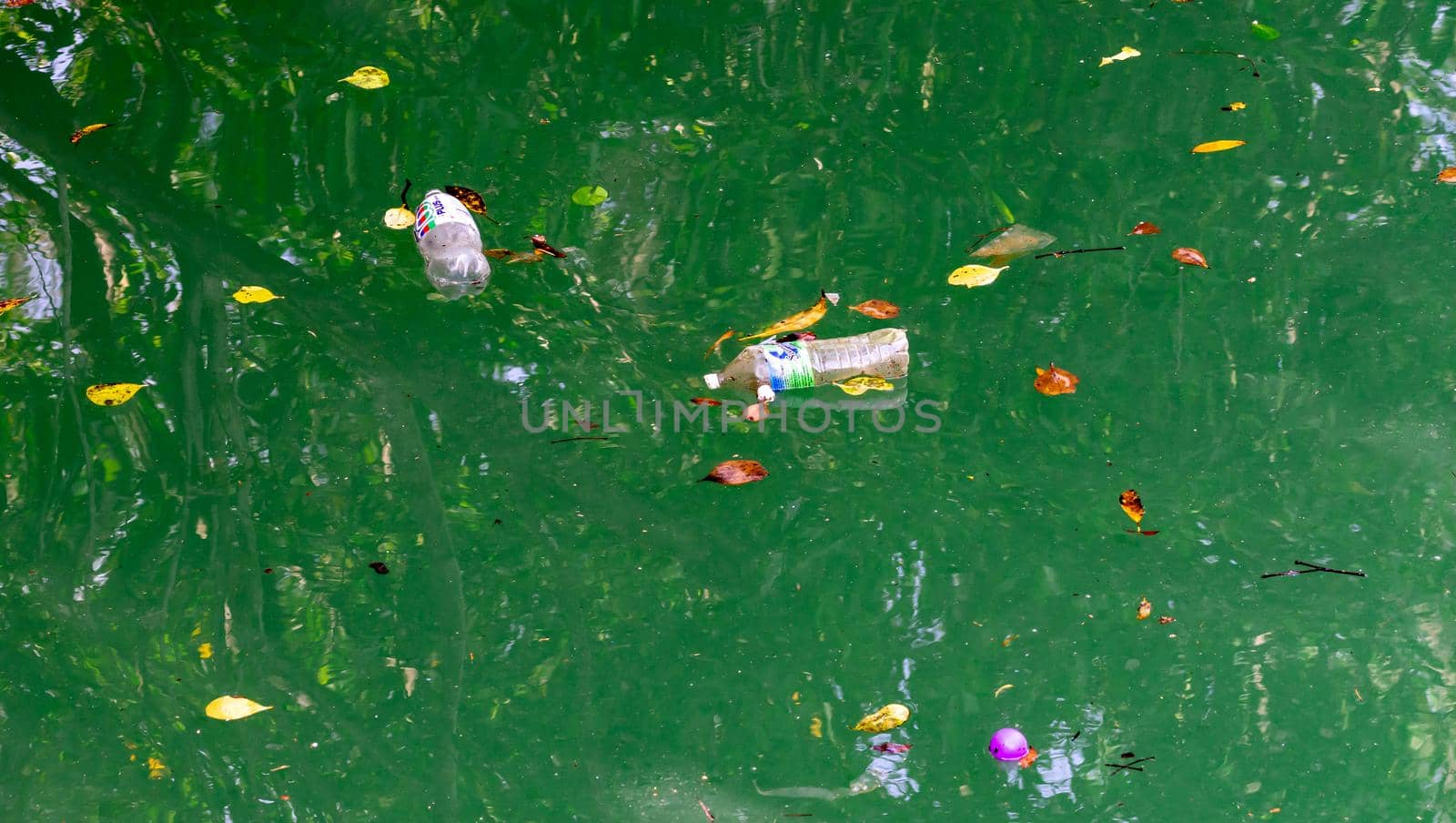 Bottled waters while floating on a river polluting the waters