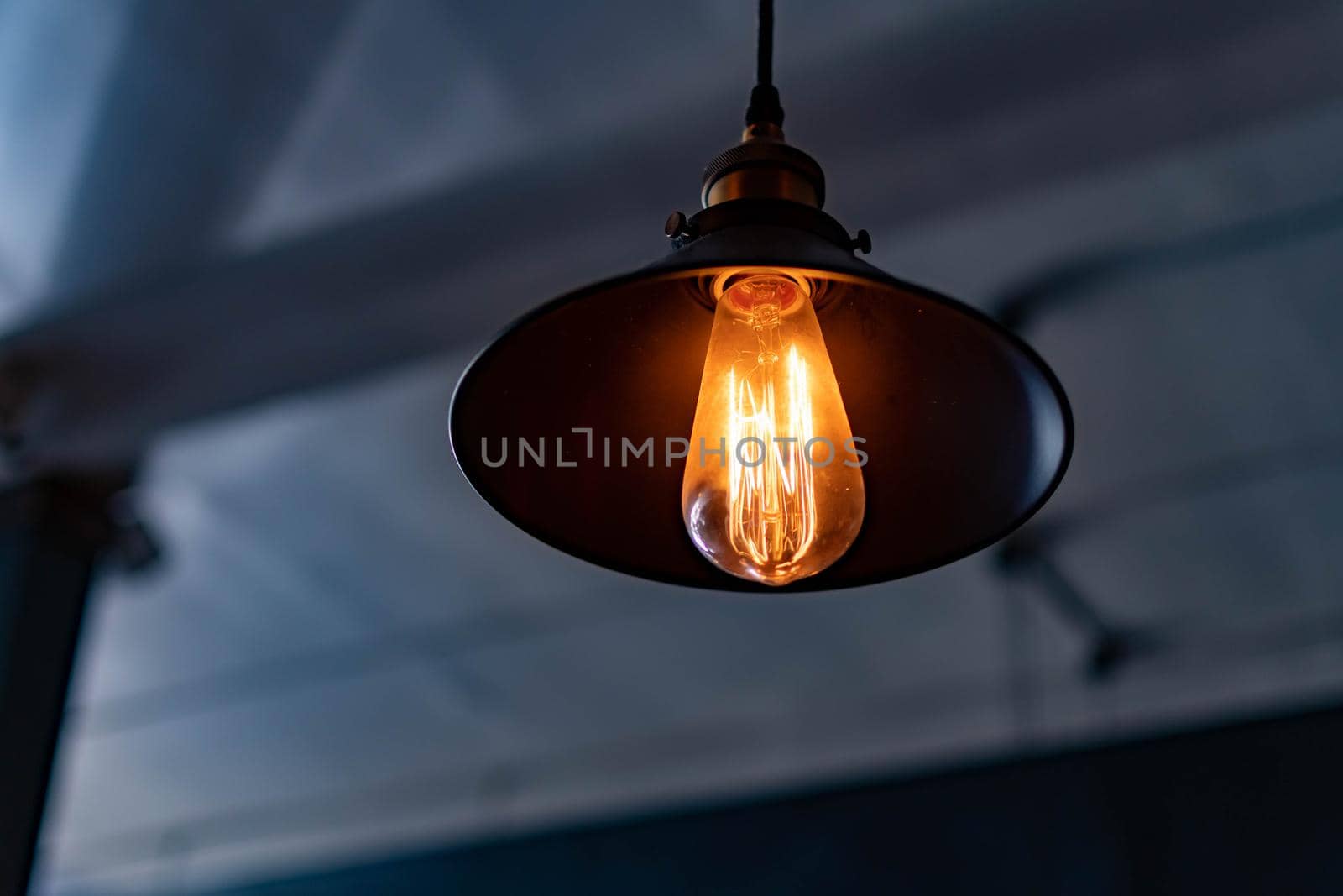 Vintage hanging lamp with light bulb over blurry background