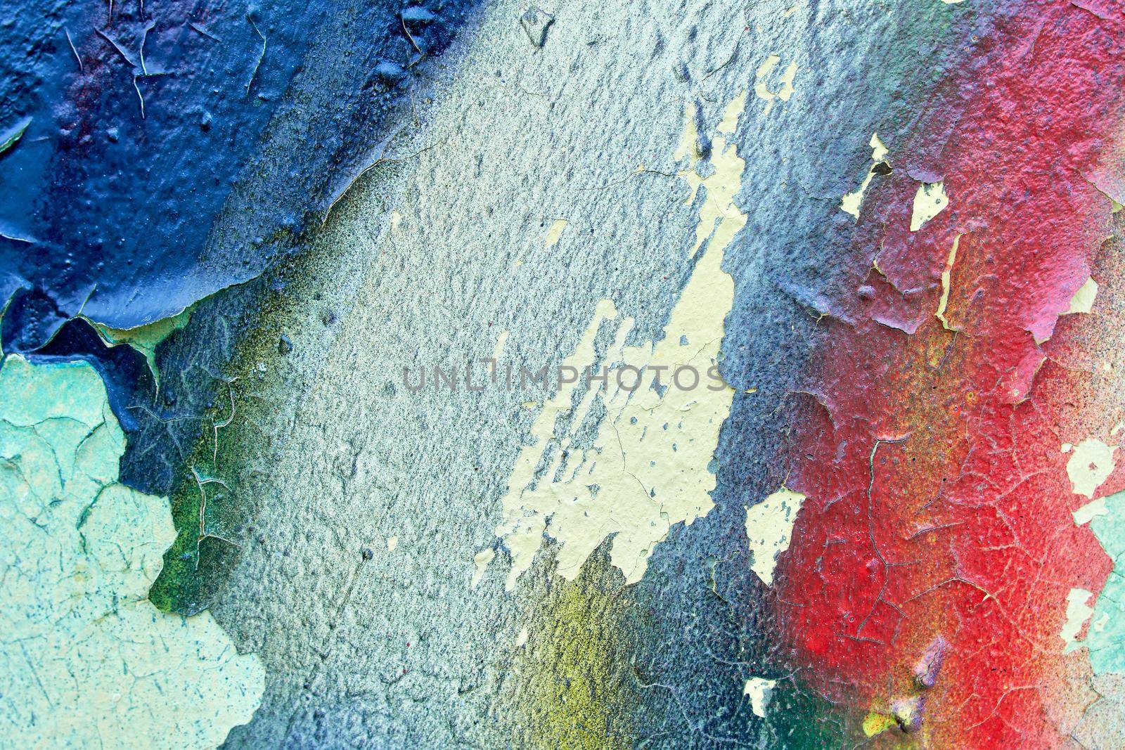 Metallic colorful background with peeling paint and blue stains and rust, texture.