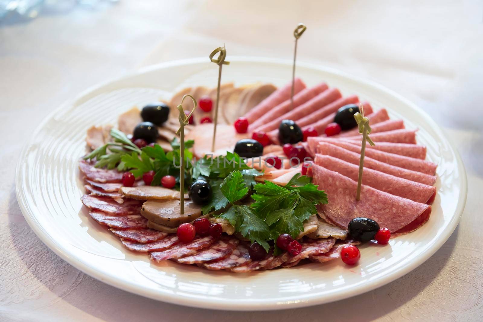 Buffet Dish. Sausage cut decorated with greens