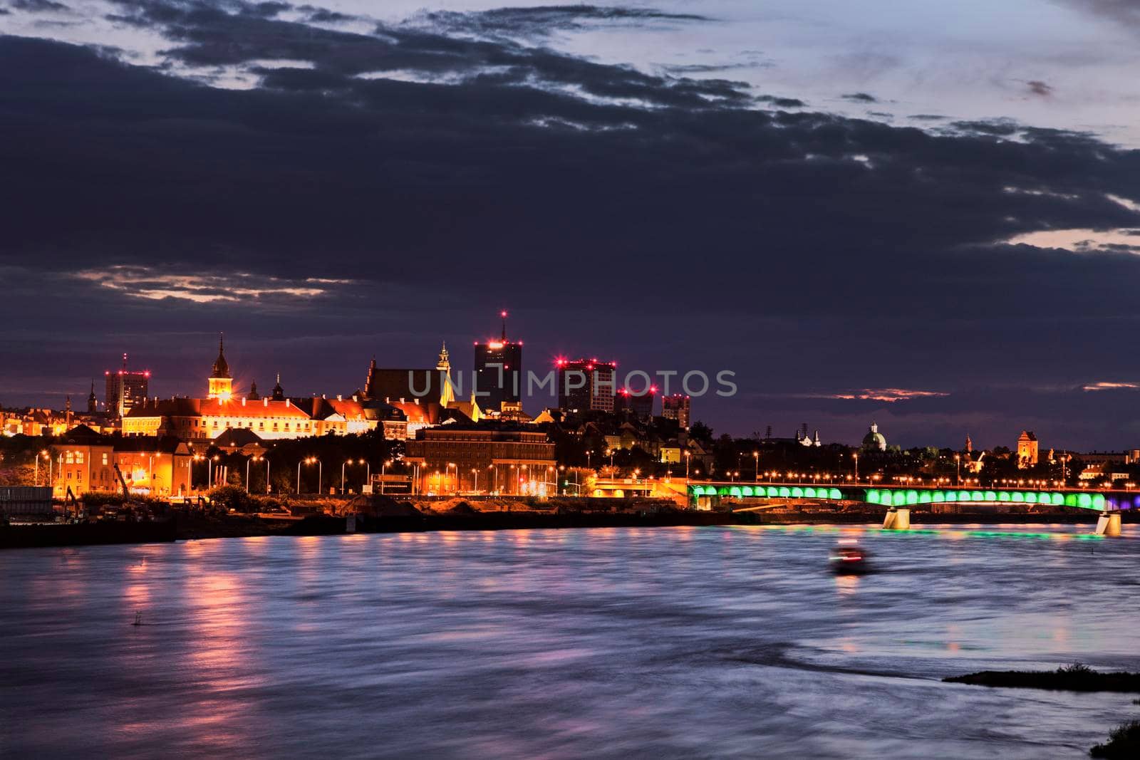 Old Town of  Warsaw accross Vistula River at sunset